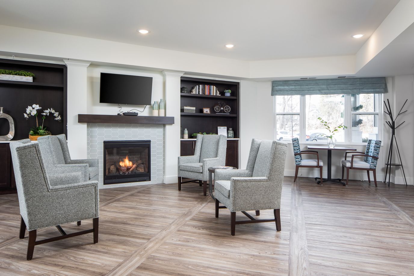 Common area with chairs and a fireplace