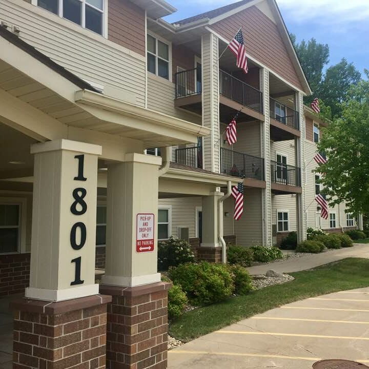 Exterior view of the facility with flags and landscaping