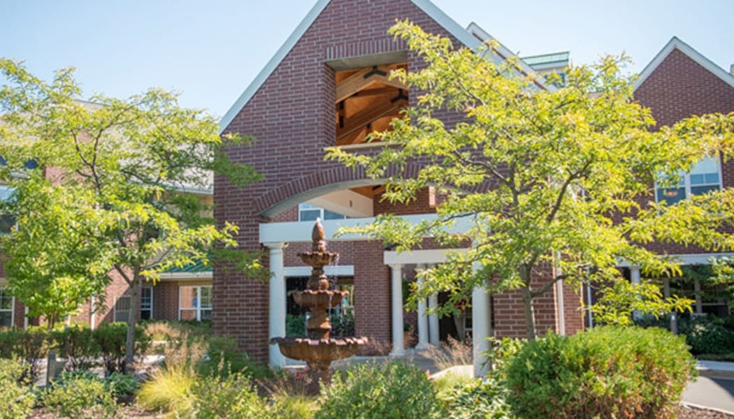 Exterior view of a senior living facility with landscaping