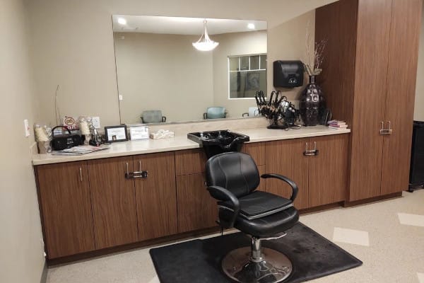 Salon area with styling chair and mirrors