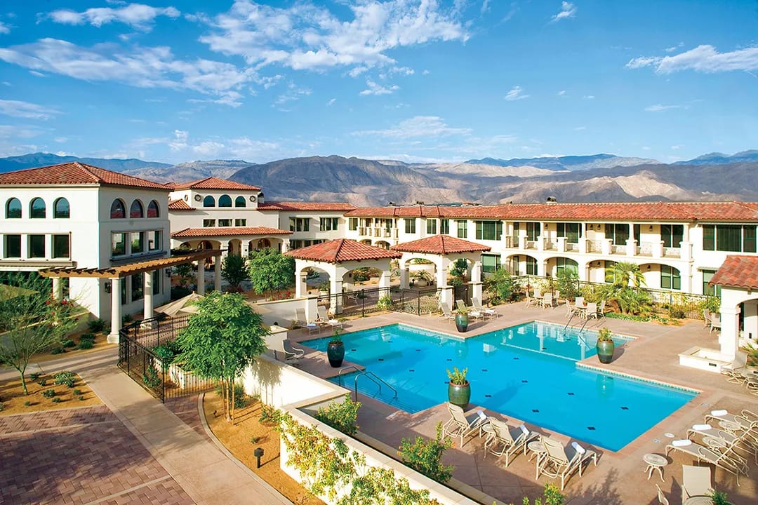 Spacious outdoor pool area with landscaped gardens.