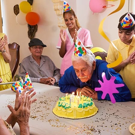 Mountainside of Warm Springs, assisted living in Warm Springs, GA — Senior residents celebrating a birthday with cake and decorations