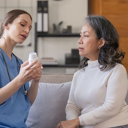 Mountainside of Warm Springs, assisted living in Warm Springs, GA — Healthcare professional consulting with a senior resident