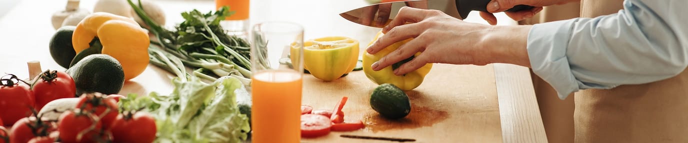 Hands preparing food with fresh vegetables