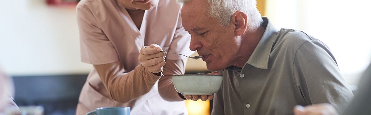 Mountainside of Warm Springs, assisted living in Warm Springs, GA — Caregiver assisting a senior with a meal