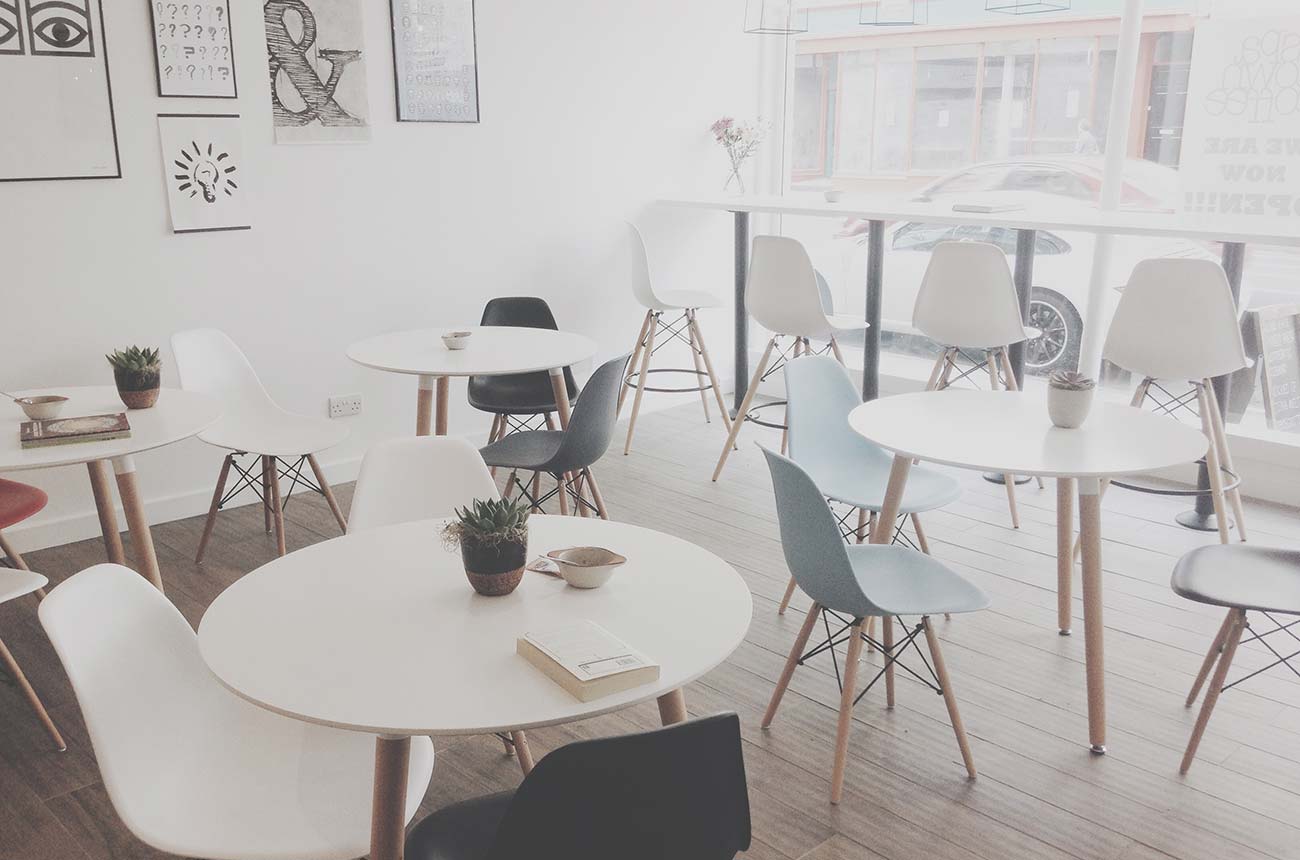 Bright interior with empty dining area and modern chairs.
