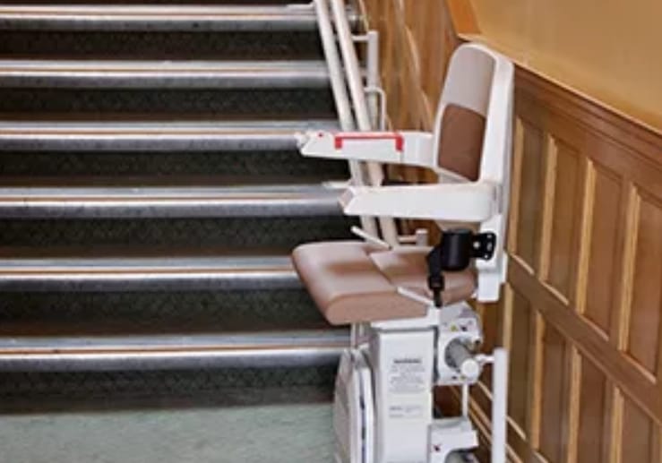 Stairlift positioned at the bottom of a staircase.
