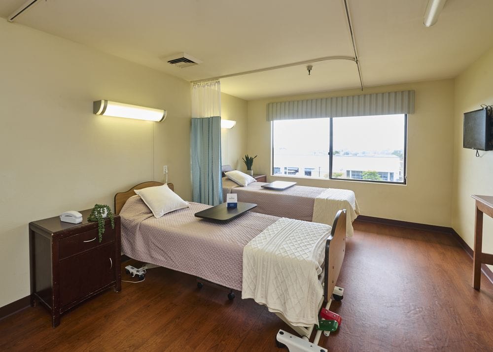 Private resident room with beds and window