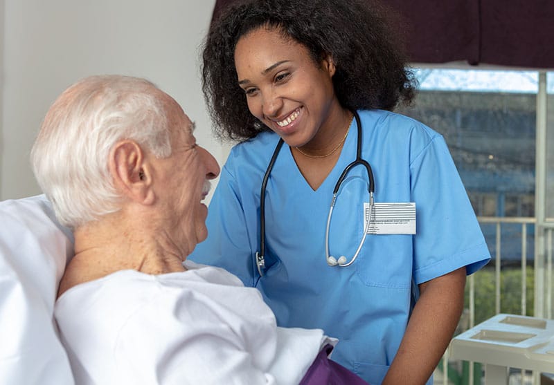 Nurse interacting warmly with an elderly resident