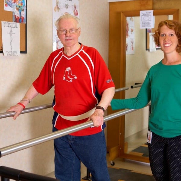 Resident receiving physical therapy assistance