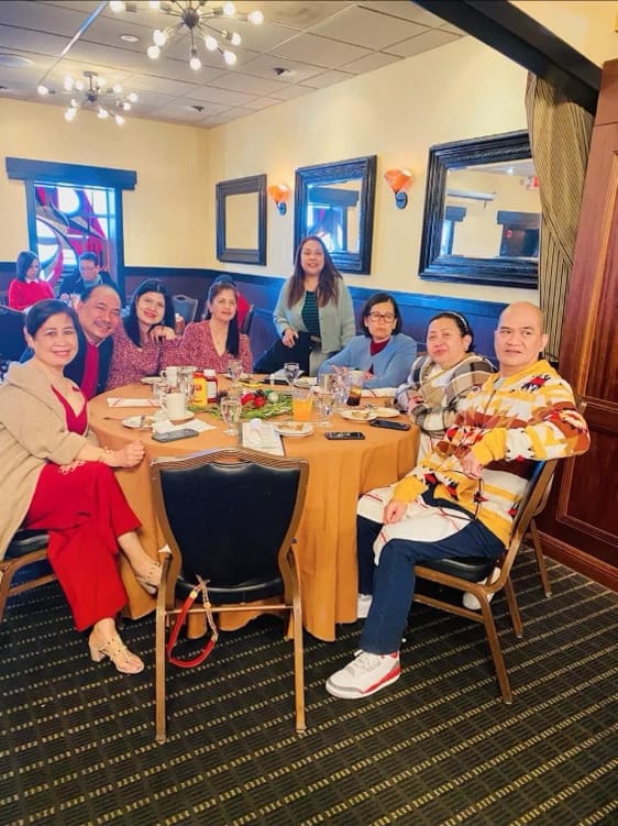 Group of people having a meal in a dining room