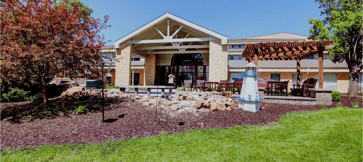 Exterior view of the assisted living facility with landscaped garden