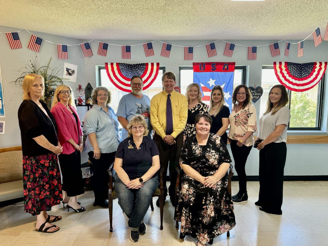 Staff and residents celebrating together in a decorated common area