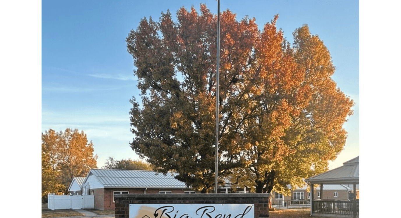 Exterior sign of Big Bend Retreat with autumn foliage
