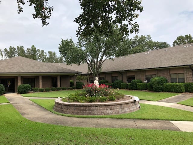 Exterior view of Heritage House Nursing Center and garden area