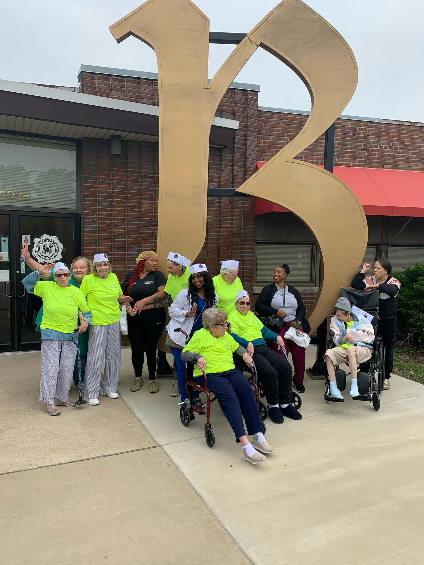 Residents and staff celebrating outside the facility building