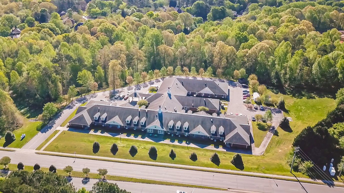 Aerial view of Terrace Ridge Assisted Living facility surrounded by trees
