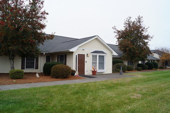 Exterior view of Rose Tara Senior Living building with landscaped area