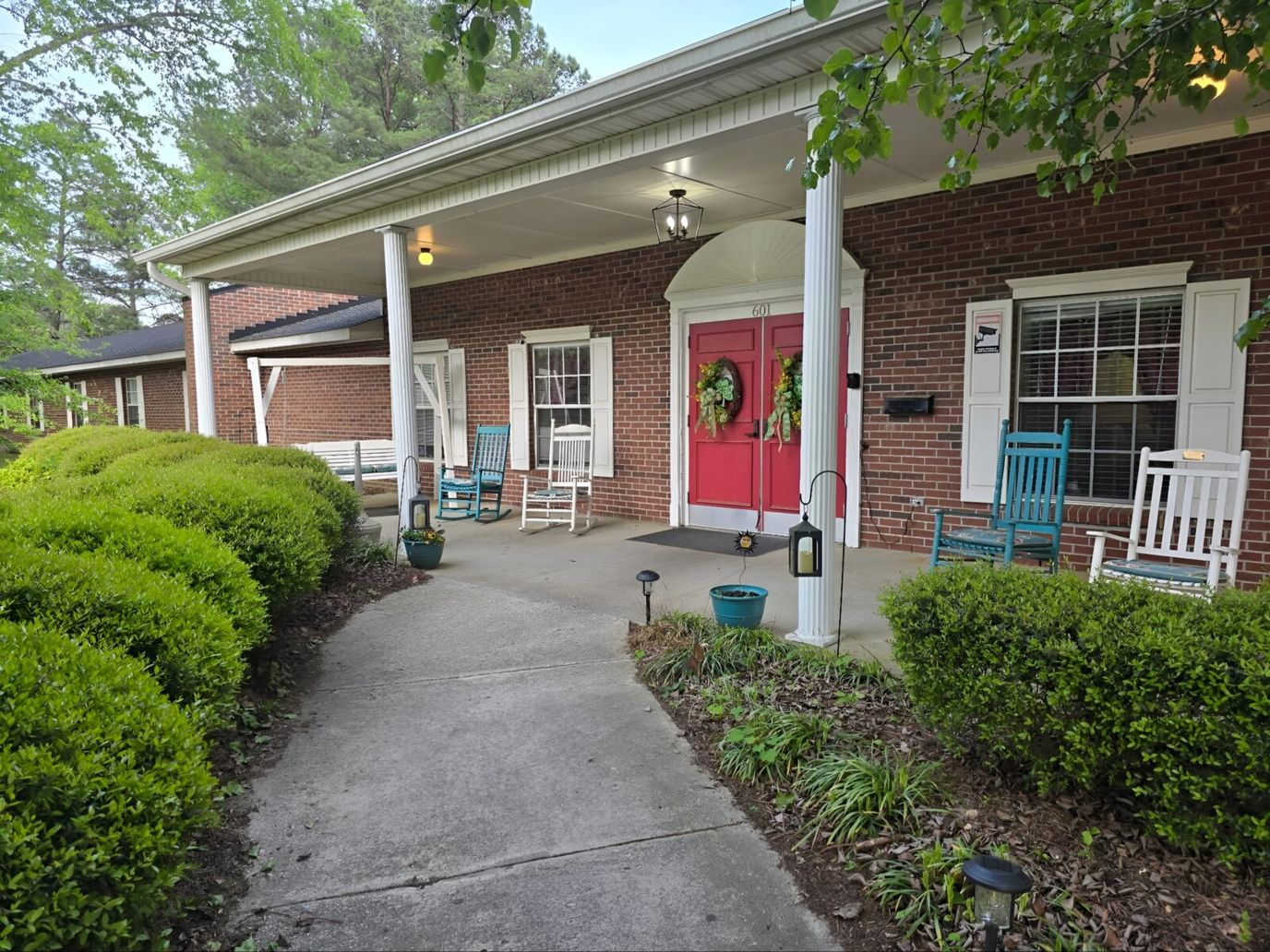 Front entrance of Lawndale Manor with seating