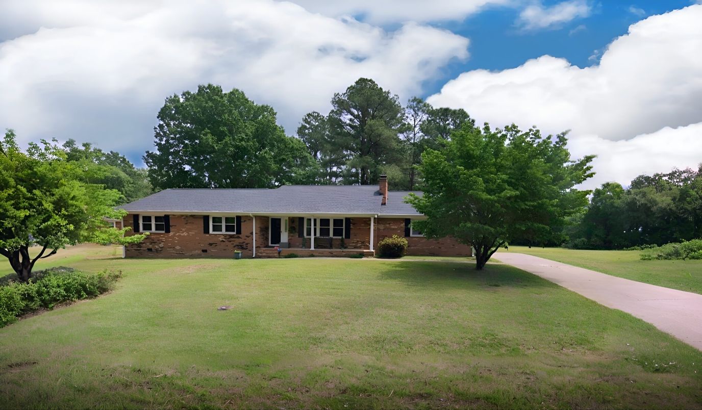 Exterior view of a single-story building surrounded by trees