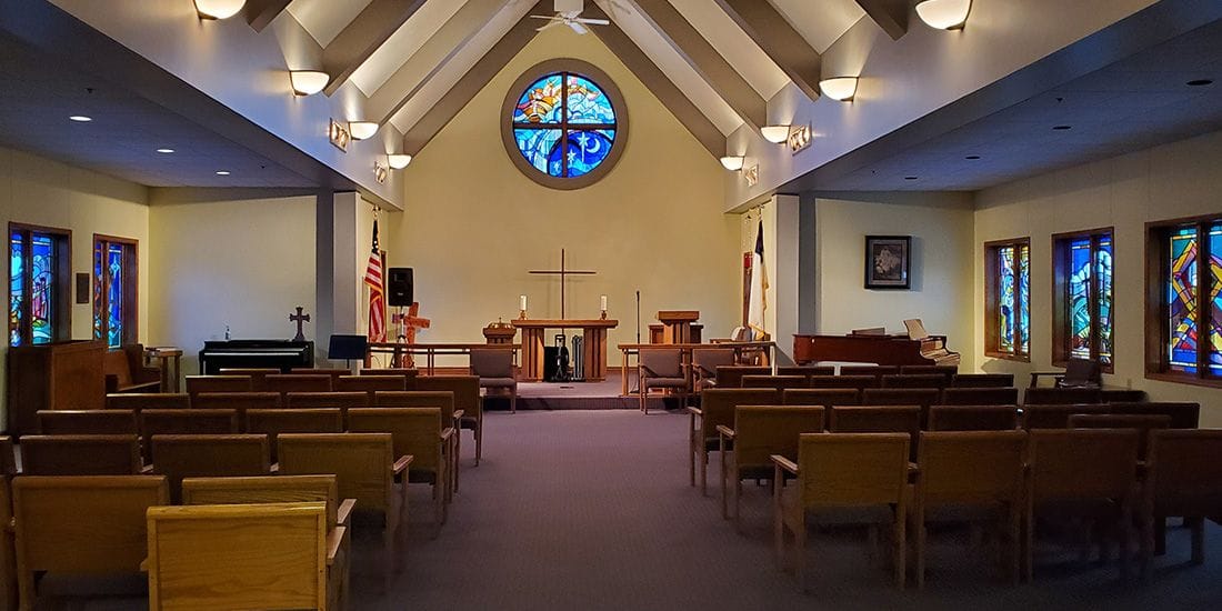 Interior view of a chapel with stained glass windows