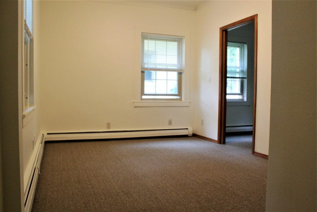Empty private room with carpet and windows