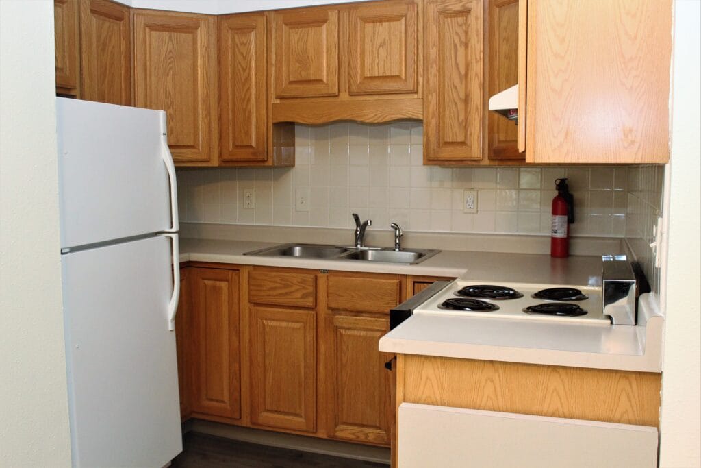 Modern kitchen with wooden cabinetry and appliances.