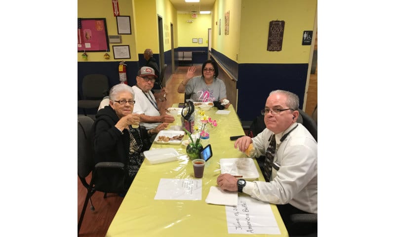 Residents enjoying a meal at a dining table