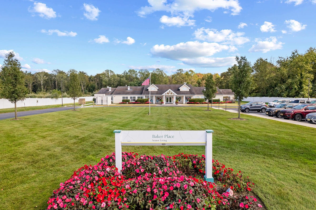 Exterior view of Baker Place with landscaping and flag