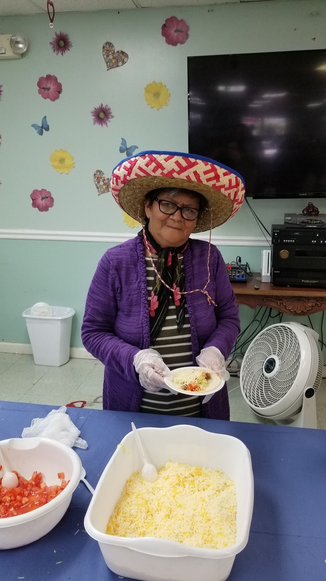 A resident serving food in a festive setting