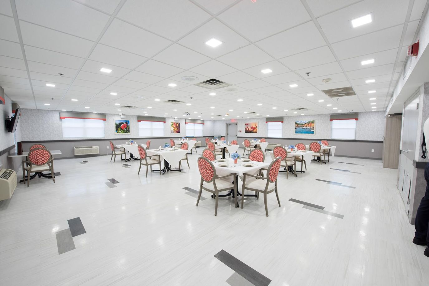 Bright, spacious dining room with tables and chairs