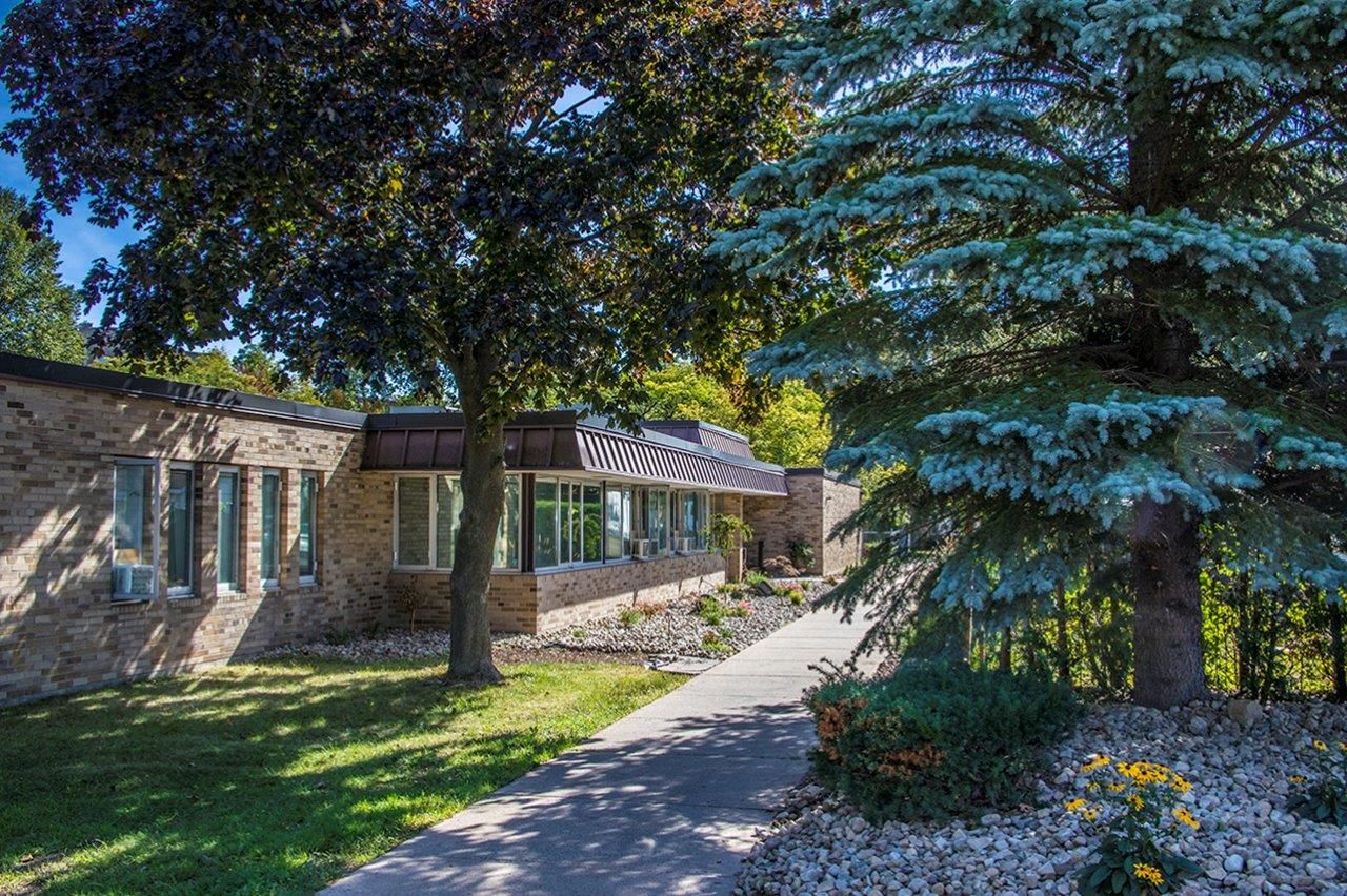 Exterior view of a nursing facility with landscaped walkway