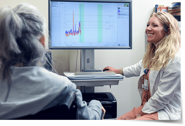 A staff member consulting with a resident using a computer