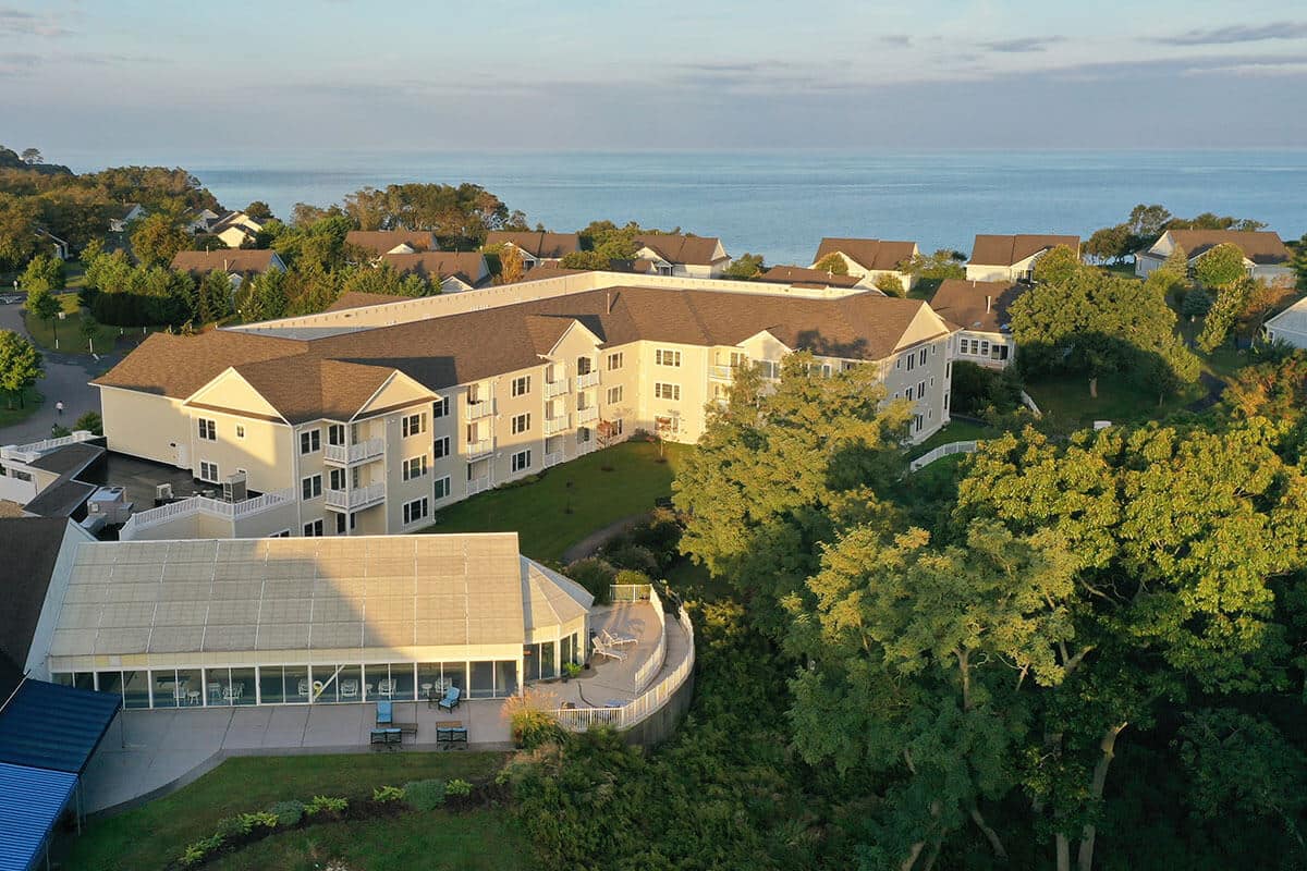 Aerial view of a senior living facility overlooking the water