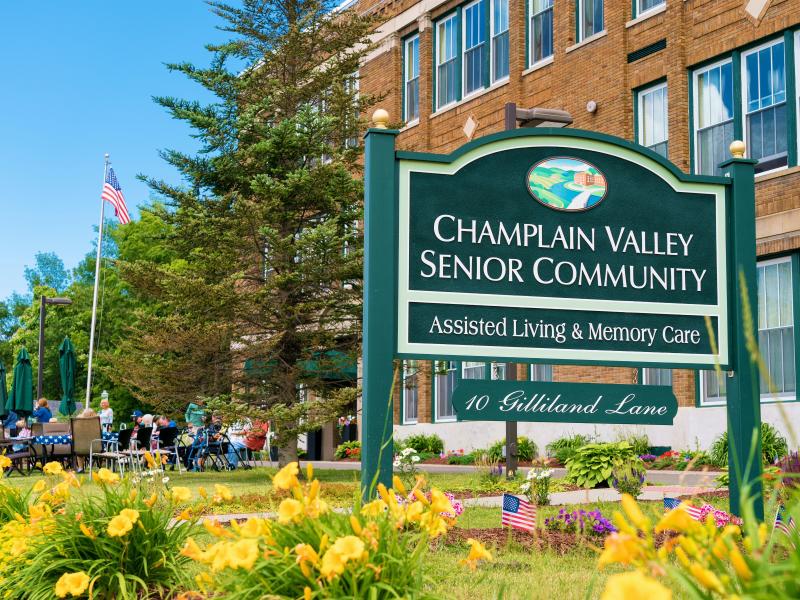 Signage for Champlain Valley Senior Community with outdoor seating