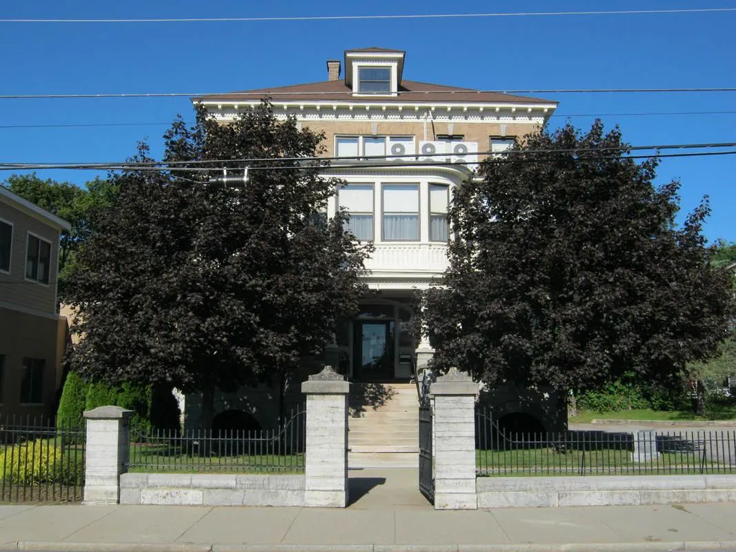 Exterior view of the Sarah Jane Sanford Home with trees