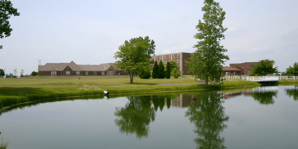 Facility building and outdoor space beside a pond