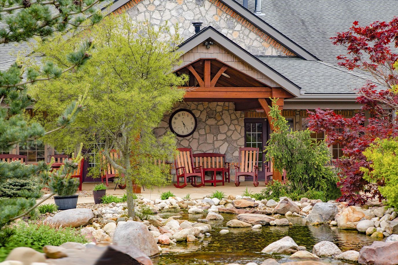 A cozy outdoor seating area with a pond