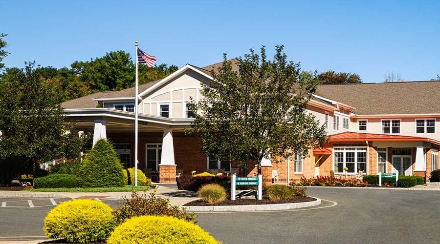 Exterior view of Peregrine Delmar Place with landscaped entrance