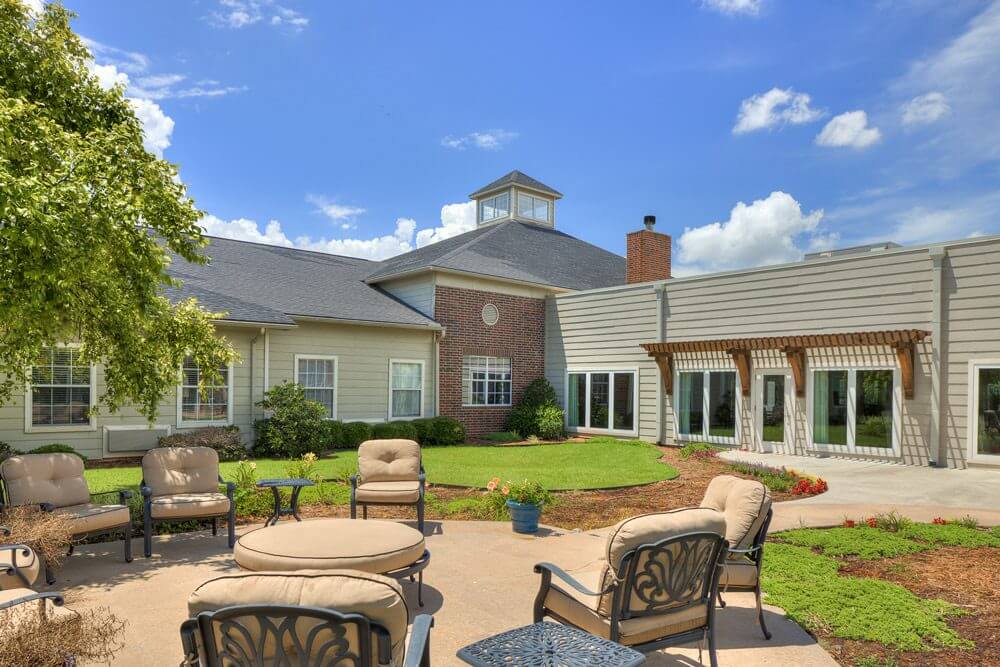 Outdoor seating area with lush gardens
