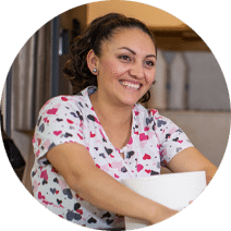 Reedwood Post Acute, Nursing Home in Portland, OR — Smiling caregiver wearing a heart-patterned uniform
