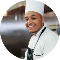 Reedwood Post Acute, Nursing Home in Portland, OR — Smiling chef wearing a white hat in a kitchen