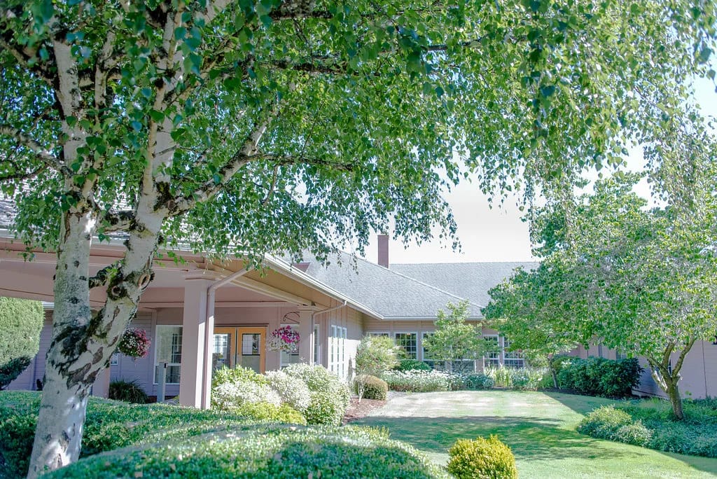 Outdoor view of Tierra Rose Care Center with trees and landscaping