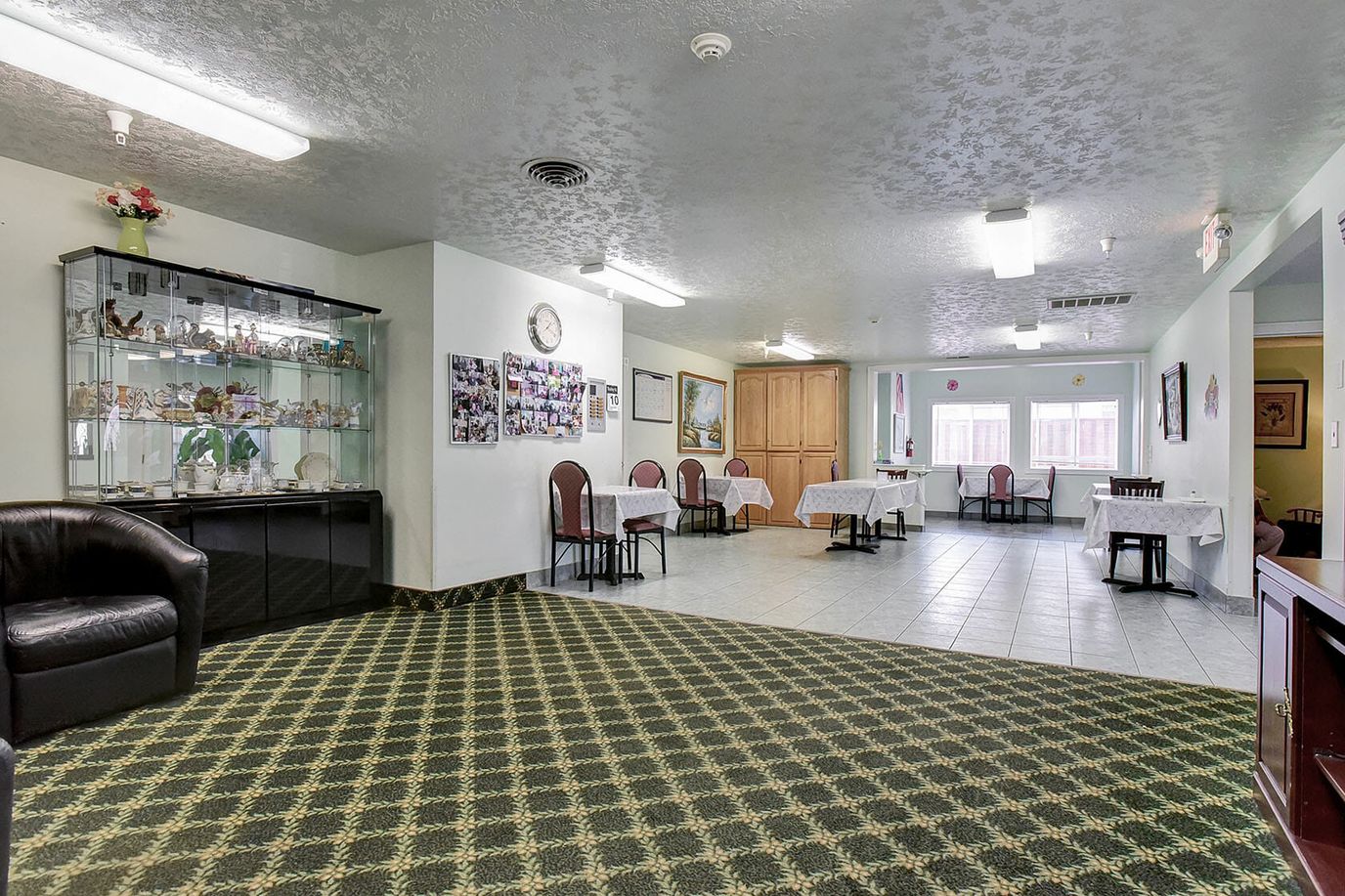 Common area with tables and chairs in a residential care facility