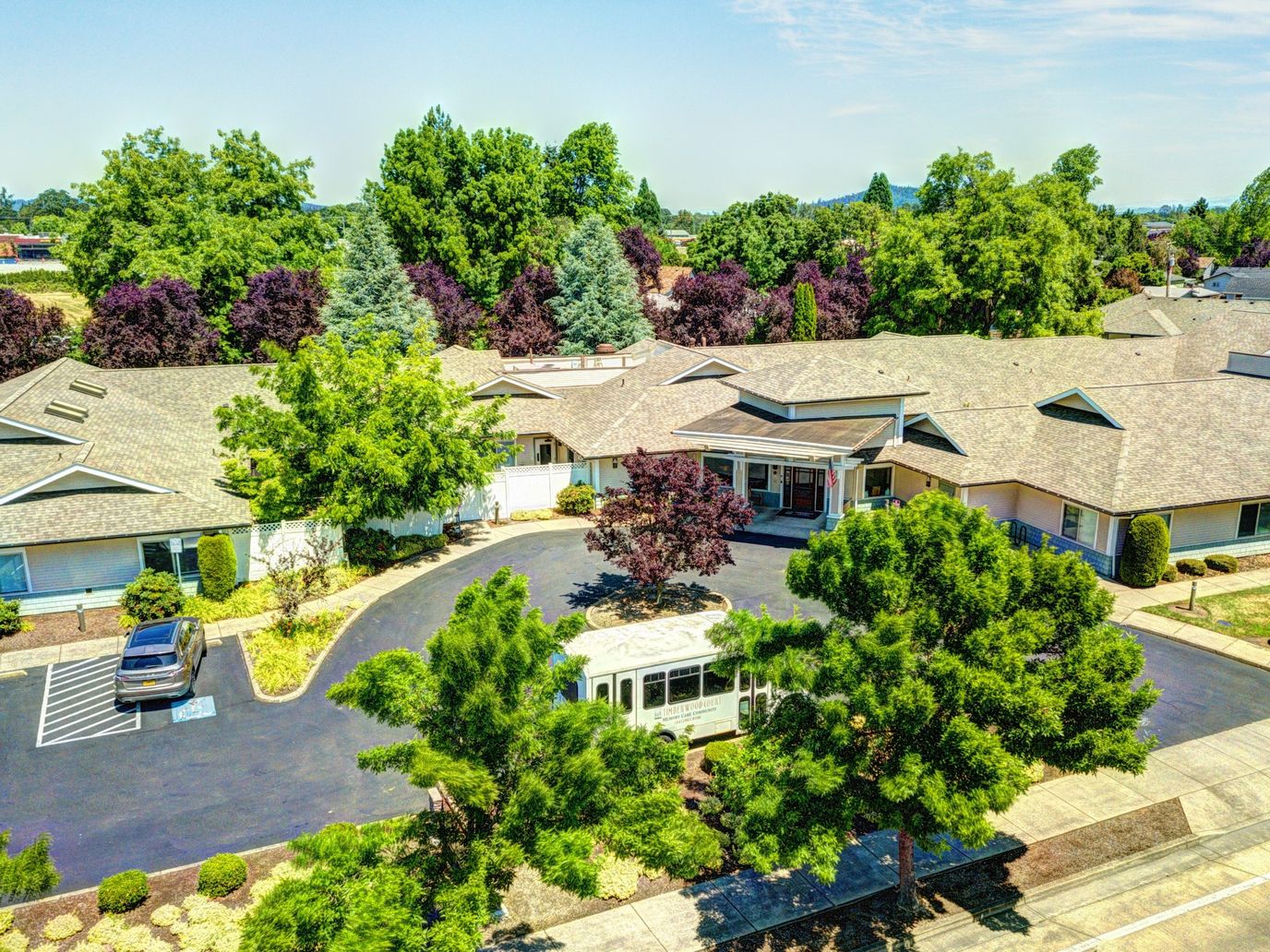 Aerial view of Timberwood Court with gardens and transport vehicle