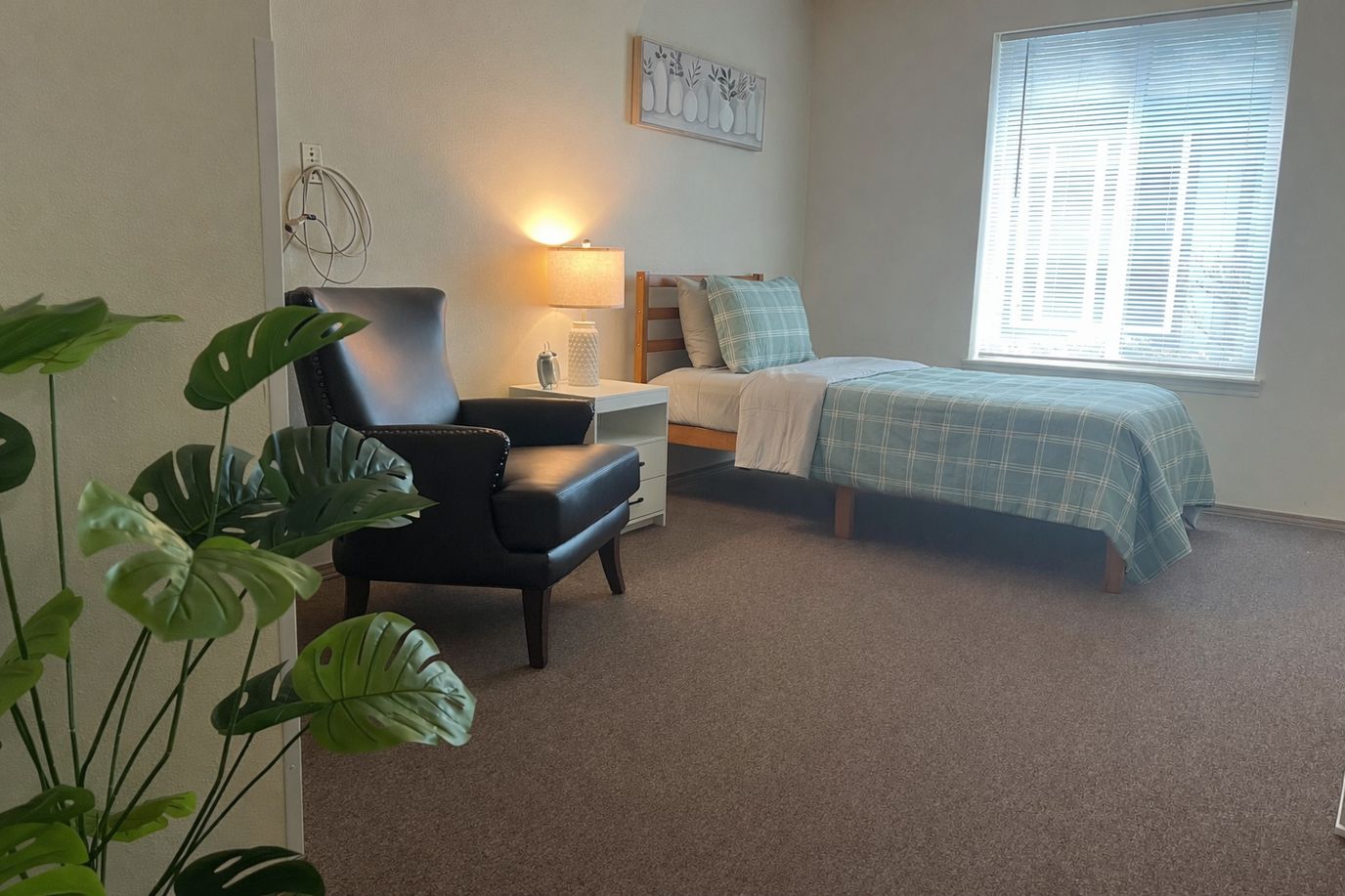 Cozy private room with a bed and chair