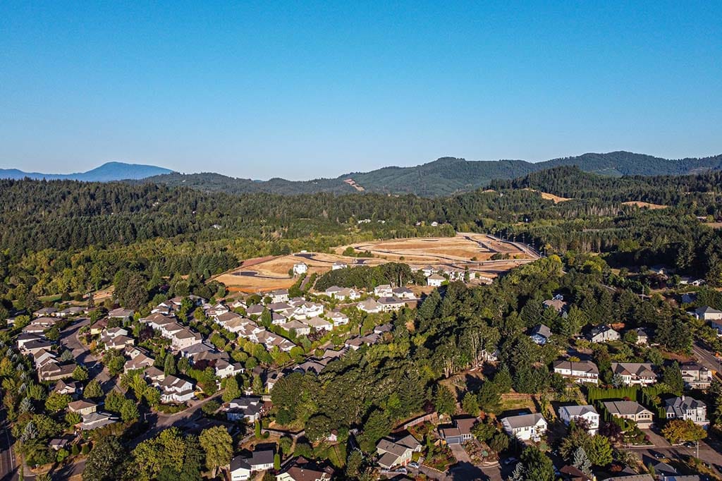 Aerial view of a residential area near hills