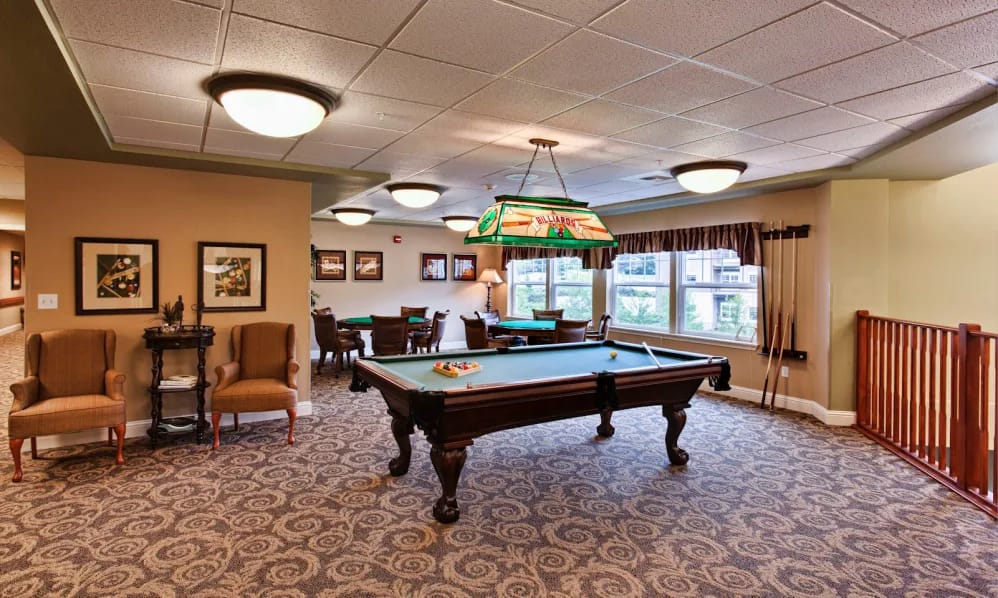 Bright common area with a pool table and seating