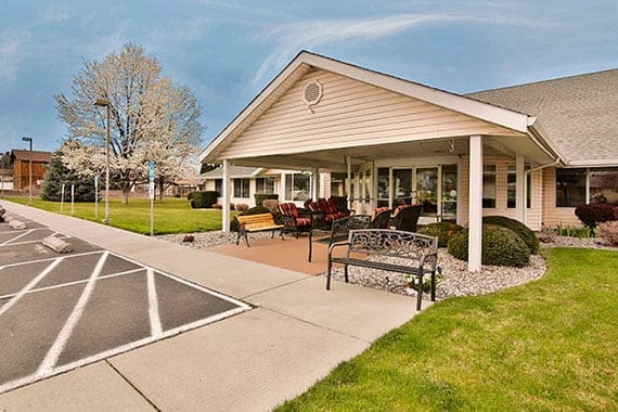 Covered patio area with seating outside the facility