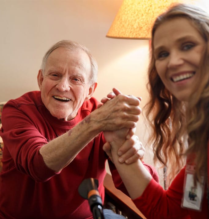 A resident smiling and engaging with a staff member